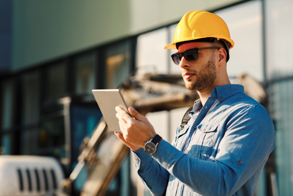 worker on a job site using an industrial tablet, which can be managed by Sparro's ARC solution, including MDM